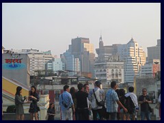 Macau skyline and numerous tourists seen from Ruinas de São Paulo.